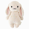 A cuddle and kind doll from the baby animal collection, baby bunny in confetti, shown from the front. Baby bunny in confetti has white fur dotted with  confetti colors.
