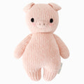 A cuddle and kind doll from the baby animal collection, baby piglet, shown from the front. Baby piglet has folded ears, a raised button nose and a blush design.