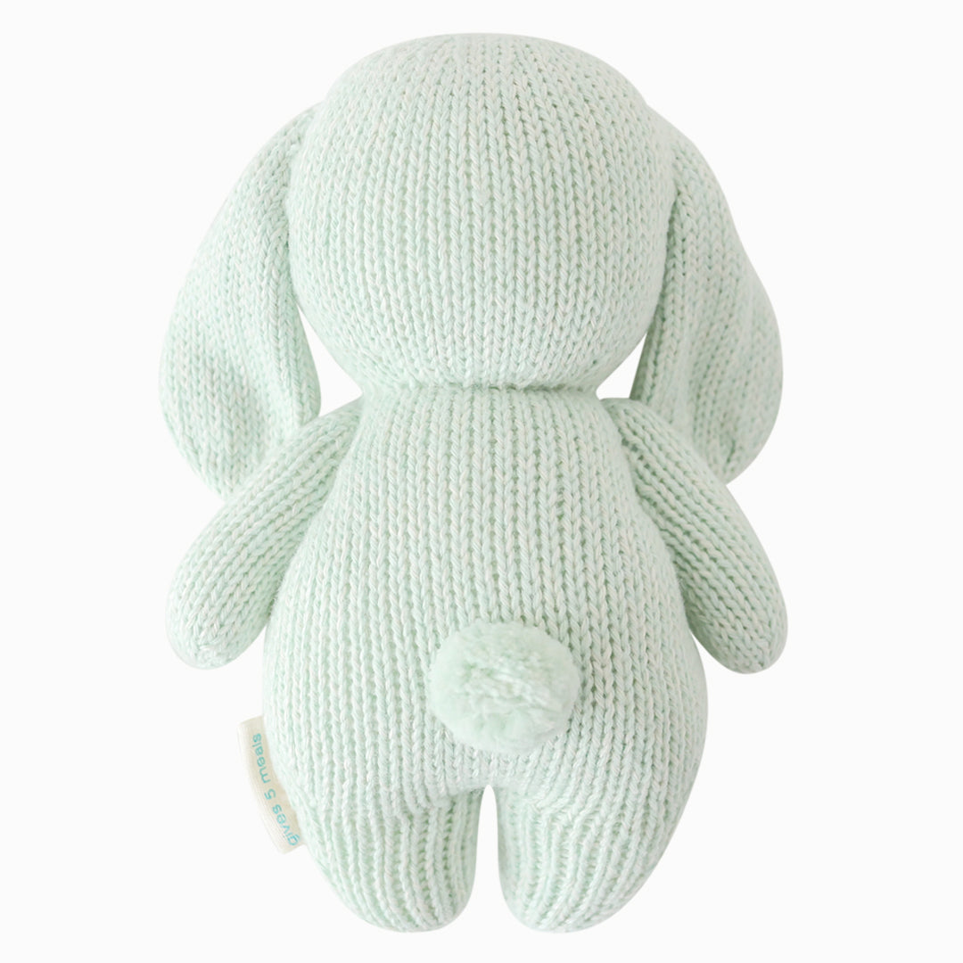 The bunny stuffed animal shown from the back. Baby bunny in mint has a fluffy, cotton tail.