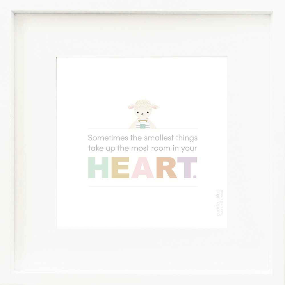 An inspirational print with a graphic of Avery the lamb on a white background with the words “Sometimes the smallest things take up the most room in your heart” in gray, with the word “heart” in rainbow block letters.