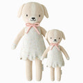 Mia the dog in the regular and little sizes, shown from the front. Mia is wearing a white dress with confetti polka dots and a pink bow.