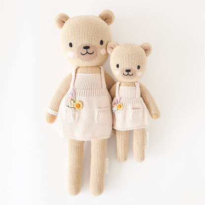 Regular and little Goldie the honey bear stuffed dolls with their arms around each other.