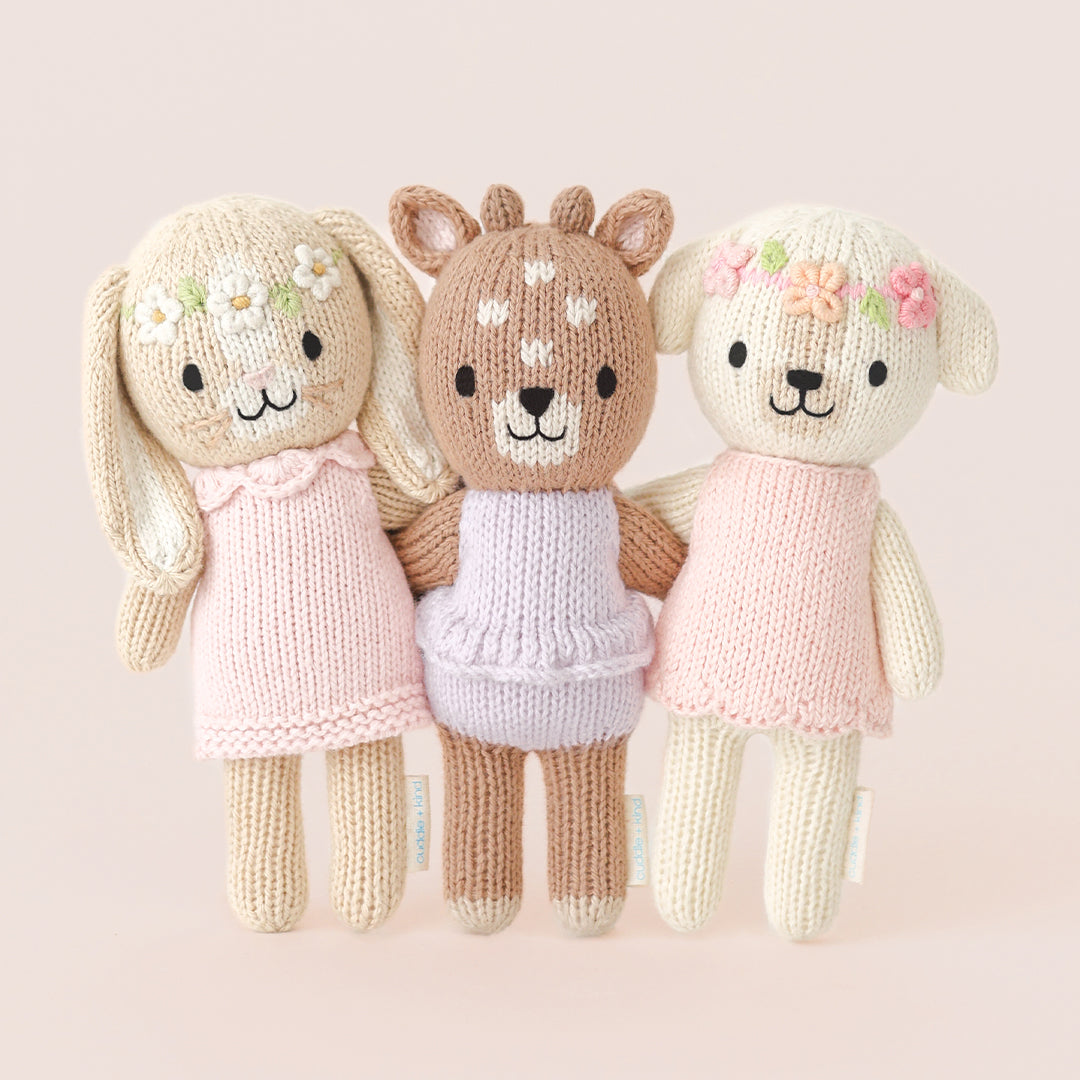 From left to right, Tiny Hannah the bunny, Tiny Violet the fawn and Tiny Charlotte the dog standing arm-in-arm with each other.