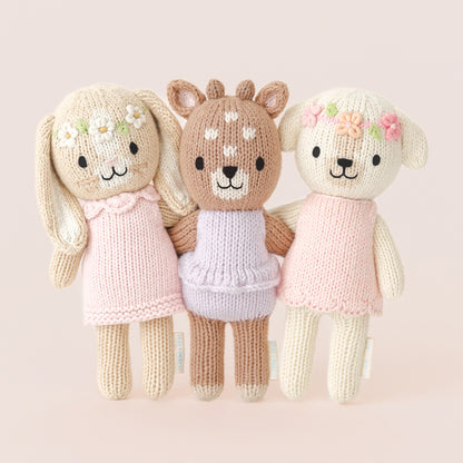From left to right, Tiny Hannah the bunny, Tiny Violet the fawn and Tiny Charlotte the dog standing arm-in-arm with each other.