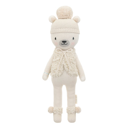 Stella the polar bear shown from 360°. Stella has a cream-colored pom-pom hat, a fluffy vest with a bow, and pom-poms on her boots.