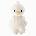A cuddle and kind doll from the baby animal collection, baby gosling, shown from the front. Baby gosling is white, with fluffy wings and a tuft of feathers on its head.