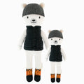 Hudson the polar bear in the regular and little sizes, shown from the front. Hudson has a dark grey hat, black vest and winter boots.