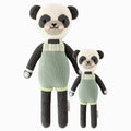 Paxton the panda in the regular and little sizes, shown from the front. Paxton is wearing a green romper with chartreuse ribbed cuffs and knit buttons.