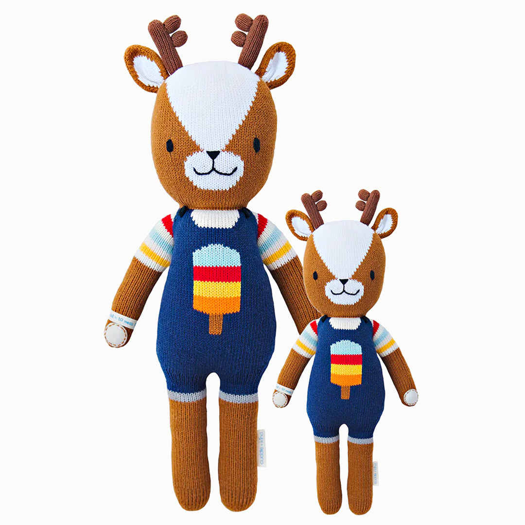 Scout the deer in the regular and little sizes, shown from the front. Scout is wearing a rainbow-striped t-shirt and blue overalls with a popsicle on the front.