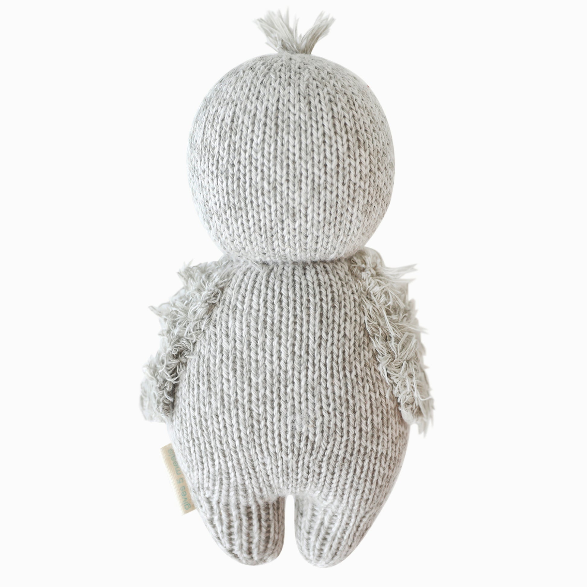 The baby penguin stuffed animal shown from the back.