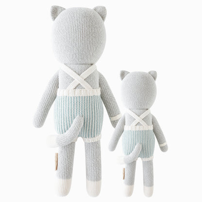 Cuddle and kind doll Dylan the kitten in the regular and little sizes, shown from the back. Dylan’s tail is poking out the back of his romper, and the straps of his romper are criss-crossed.