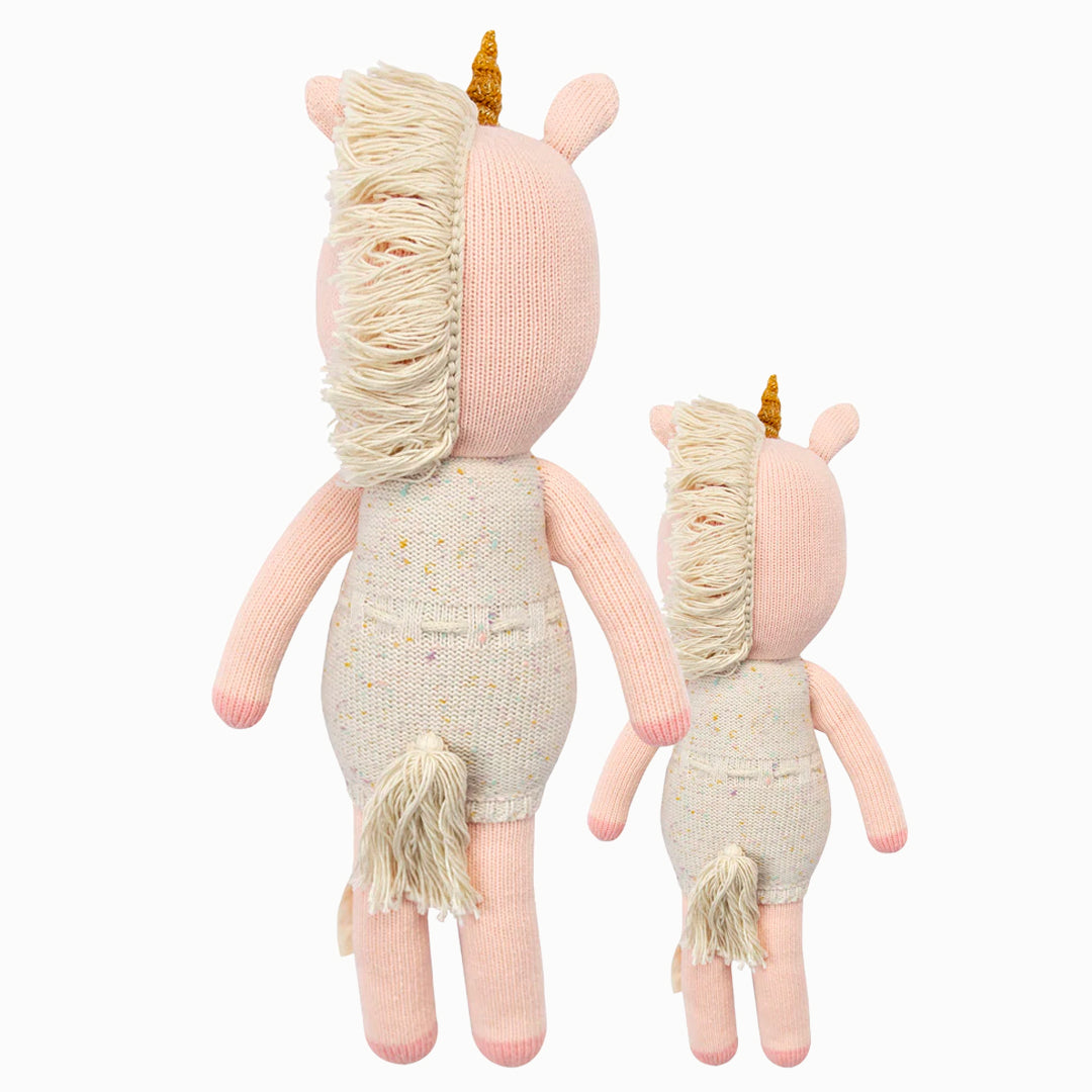 Cuddle and kind doll Ella the unicorn in the regular and little sizes, shown from the back. Ella has a tasseled mane and tail.