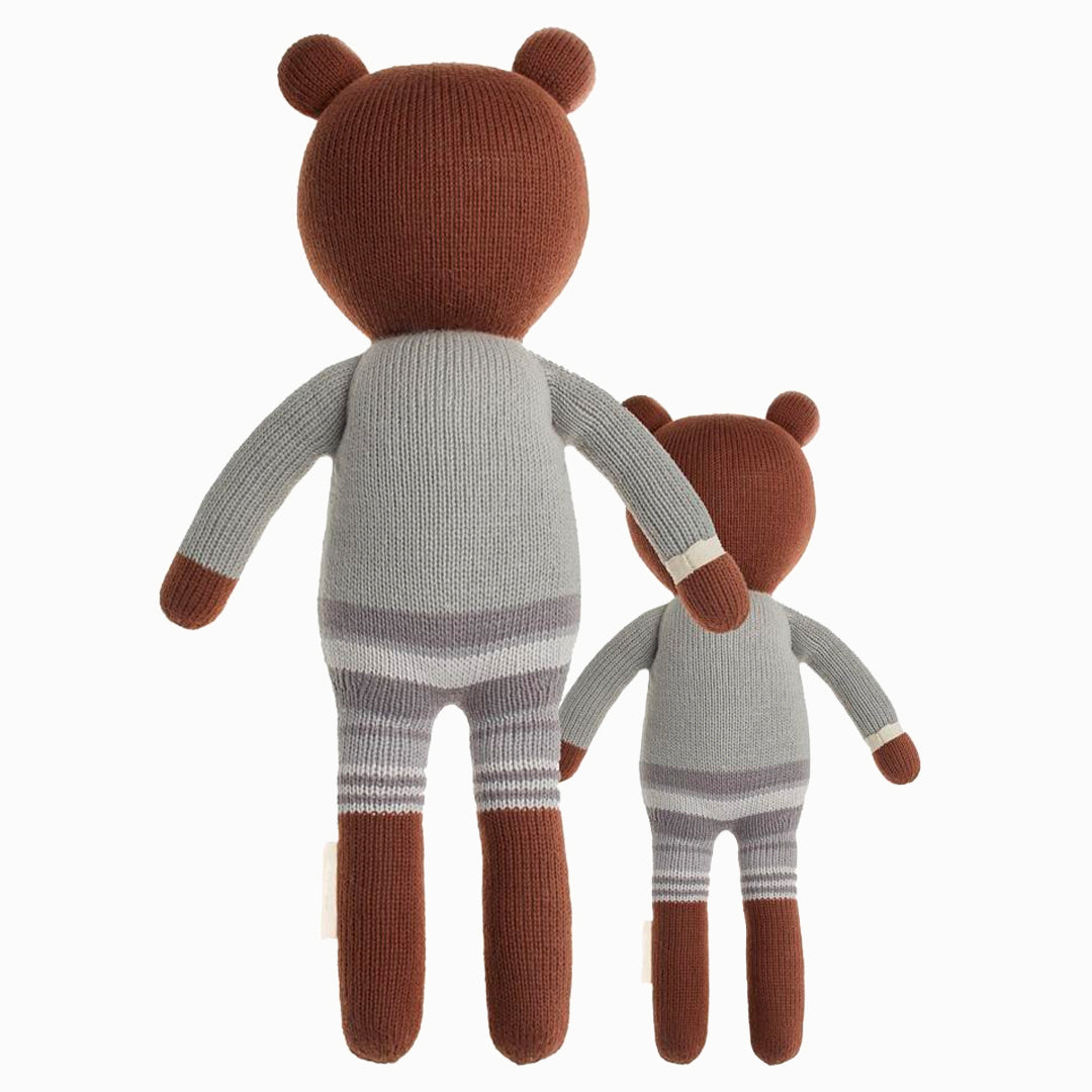 Cuddle and kind doll Oliver the bear in the regular and little sizes, shown from the back.