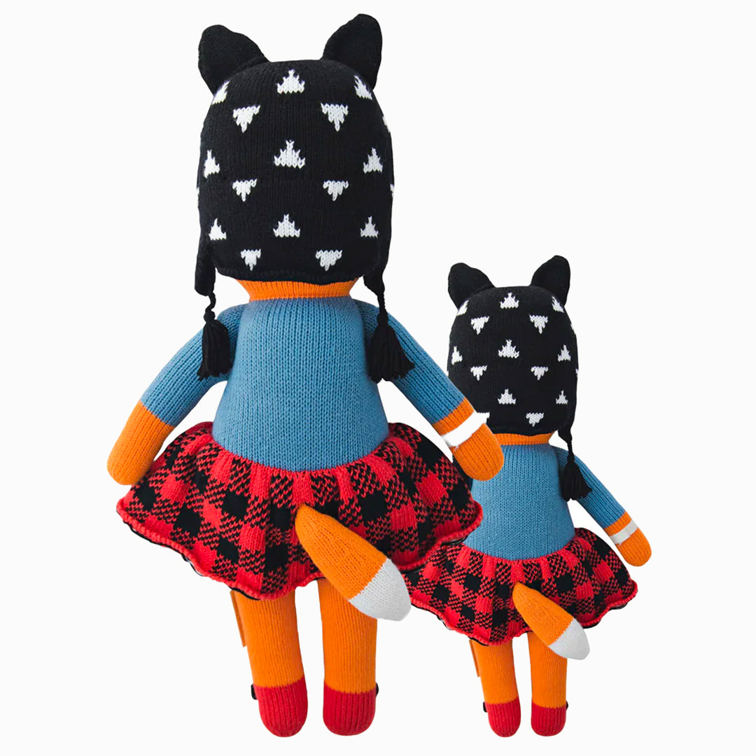 Cuddle and kind doll Sadie the fox in the regular and little sizes, shown from the back. Sadie’s tail is poking out the back of her skirt.