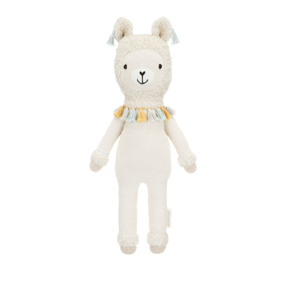 Lucas the llama shown from 360°. Lucas has blue tassels hanging on his fuzzy ears and a necklace of gray, yellow and blue tassels around his neck.