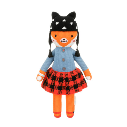 Sadie the fox shown from 360°. Sadie has a black winter hat with white accents, a blue sweater and red plaid skirt.
