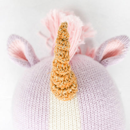 A close-up showing Zoe the unicorn’s horn, with white yarn woven among golden brown yarn.
