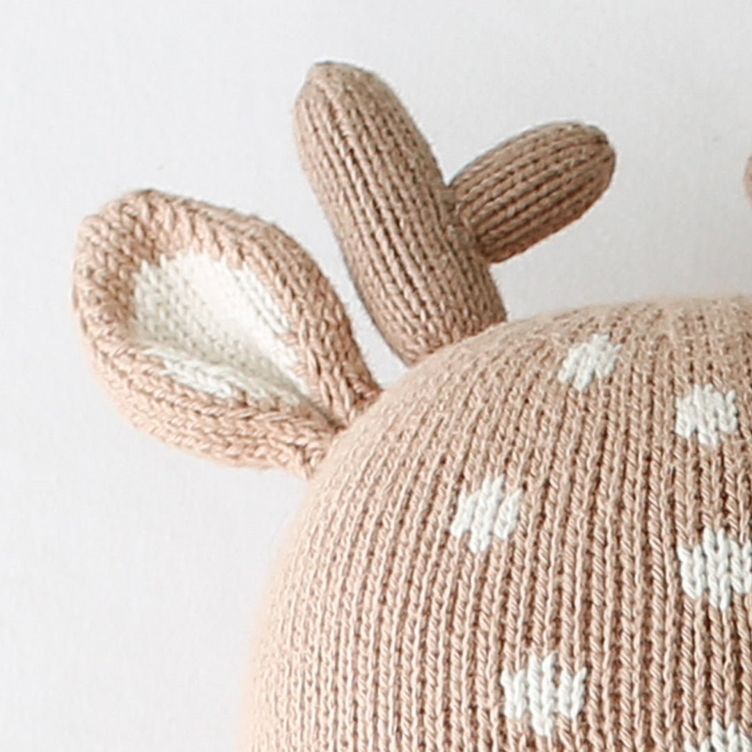 A close-up showing the hand-knit details of Elliot the fawn's antlers and white spotted forehead.