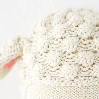 A close-up showing hand-knit details on Avery the lamb’s head.