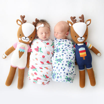 Two sleeping babies snuggled together with a Scout the deer doll and Willow the deer doll.