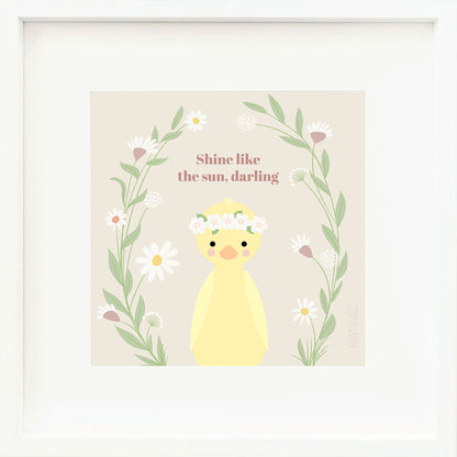 A framed print with a drawing of Flora, with text that says “Shine like the sun, darling.”