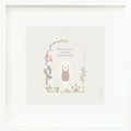 An inspirational print with a graphic of Harper the bunny surrounded by a flower covered archway on a purple background with the words “Where there’s wonder, there’s magic” in lilac.