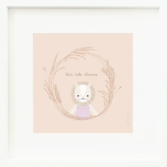 An inspirational print with a graphic of Savannah the lion inside a ring of grass with the words “Let’s take chances” in brown on a blush-colored background.