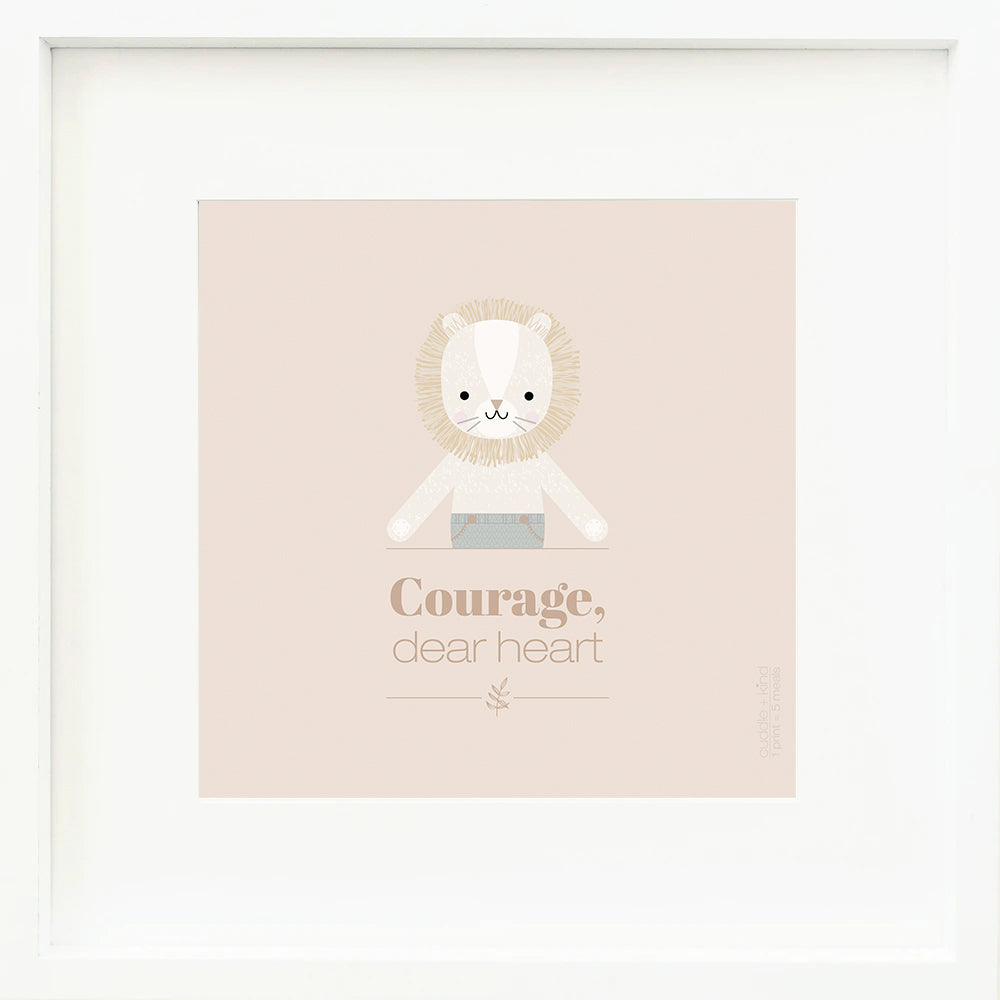 An inspirational print with a graphic of Sawyer the lion with the words “Courage, dear heart” in brown on a blush-colored background.