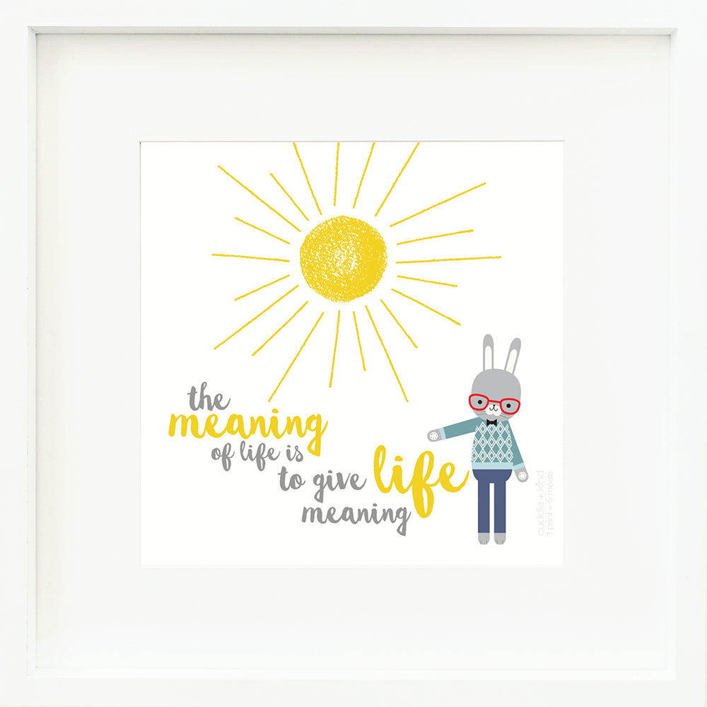 A framed print with a drawing of Benedict the bunny and text that says “The meaning of life is to give life meaning.”