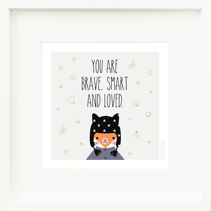 A framed print with a drawing of Sadie the fox and text that says “You are brave, smart and loved.”