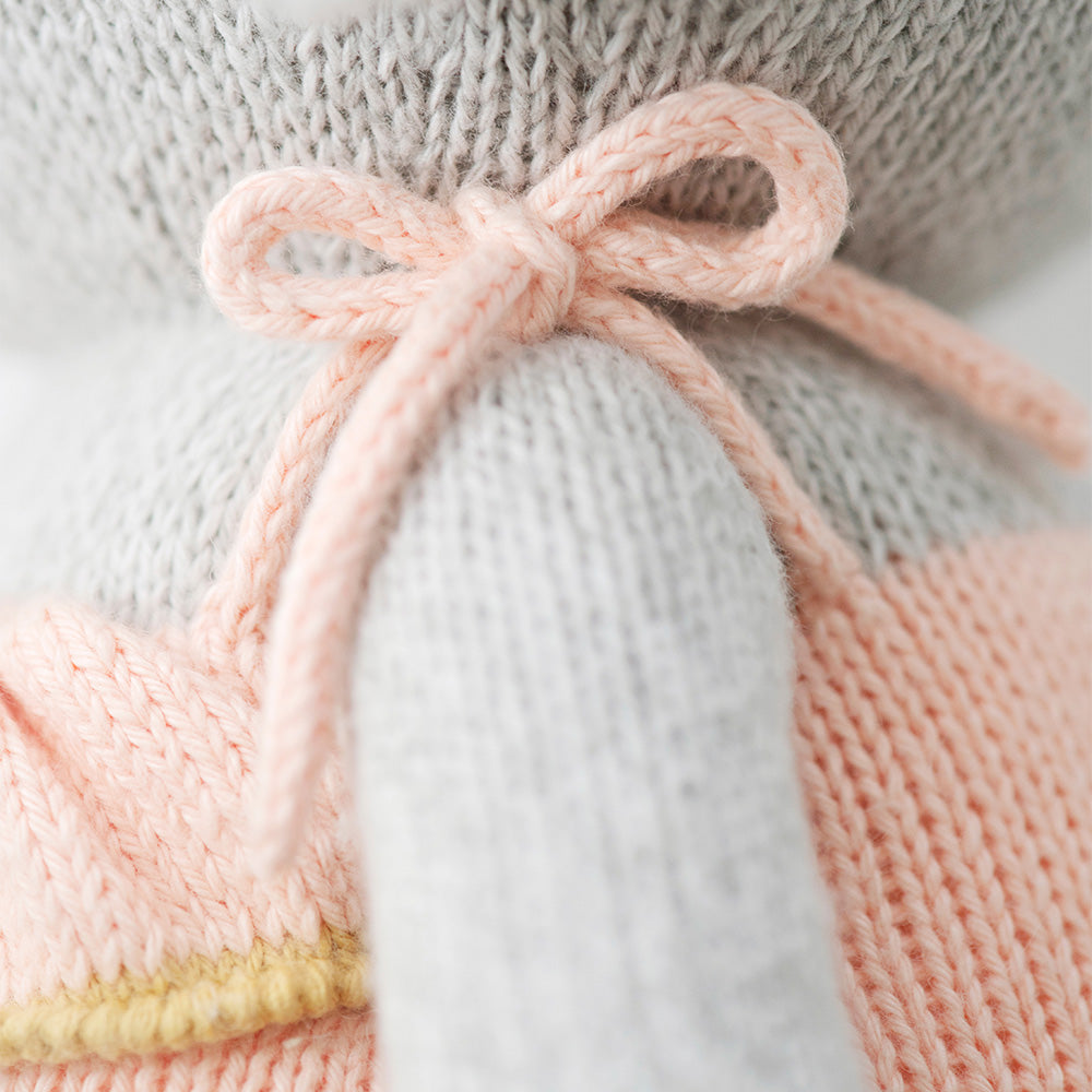 A close-up showing the bow on the shoulder of Eloise’s romper.