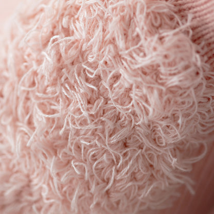 A close-up showing Penelope’s fluffy yarn wing.