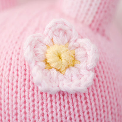 A close-up showing an embroidered flower on Chloe the bunny’s head.