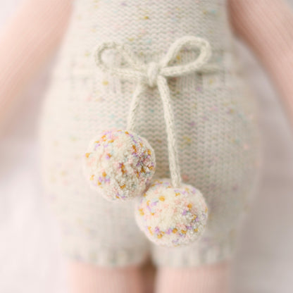 A close-up showing the confetti polka dot details in Ella the unicorn’s pom-pom waist tie.