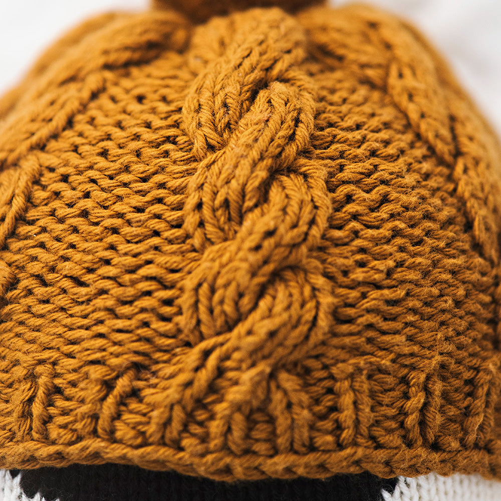 A close-up of Everest the penguin’s hat, showing its hand-knit details.