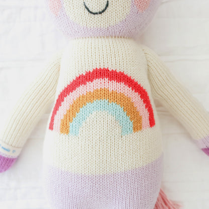 A close-up showing Zoe the unicorn’s shirt with a rainbow on it.