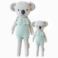 Claire the koala in the regular and little sizes, shown from the front. Claire is wearing a mint romper with ruffles.