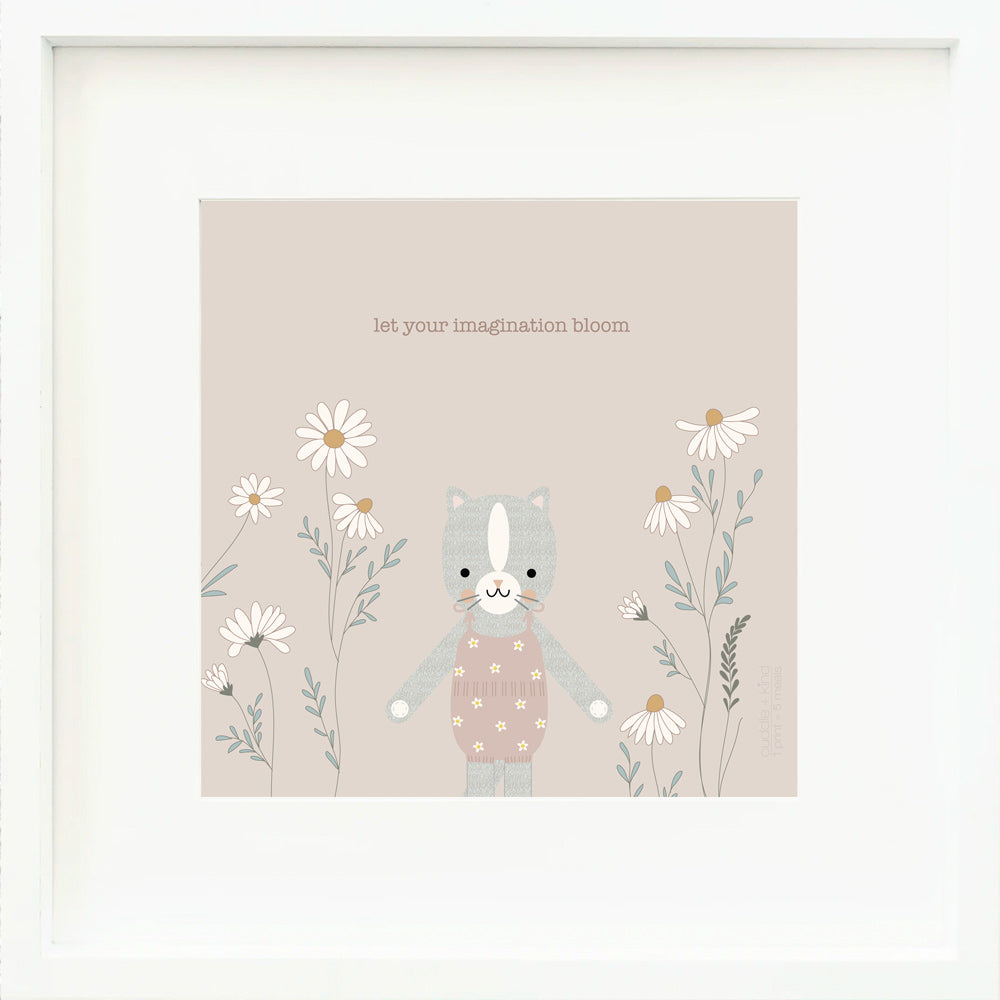 A framed print with a drawing of Daisy the kitten and text that says “Let your imagination bloom.”