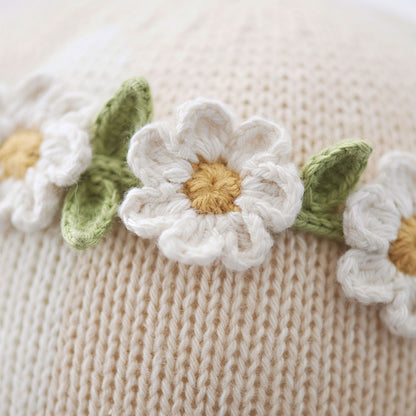 A close-up showing embroidered daisies on Hannah’s headband.