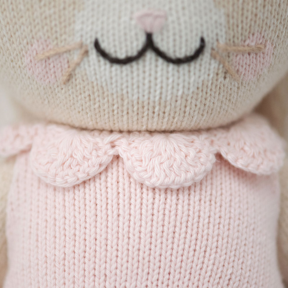 A close-up showing the hand-knit detail on the collar of Hannah’s dress.