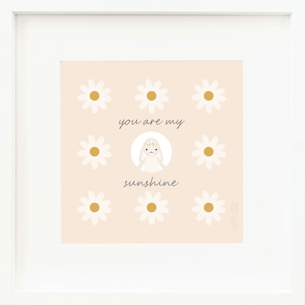 A framed print with a drawing of Hannah the bunny and text that says “You are my sunshine.”