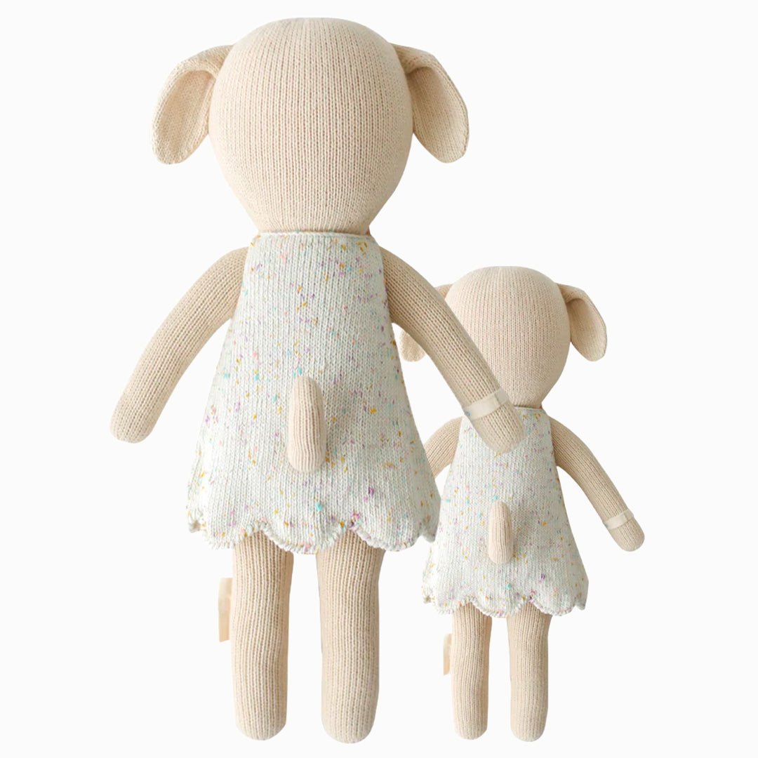 Cuddle and kind doll Mia the dog in the regular and little sizes, shown from the back. Mia’s tail is poking out the back of her dress.