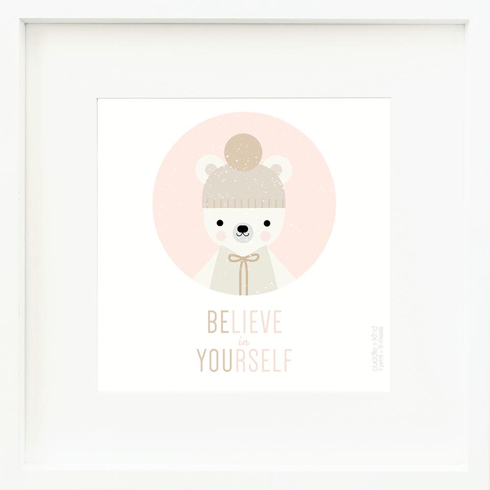 An inspirational print with a graphic of Stella the polar bear in a pink circle on a white background with the words “Believe in yourself” in pink and brown.