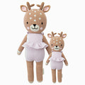 Violet the fawn in the regular and little sizes, shown from the front. Violet is wearing a purple romper with a ruffle.