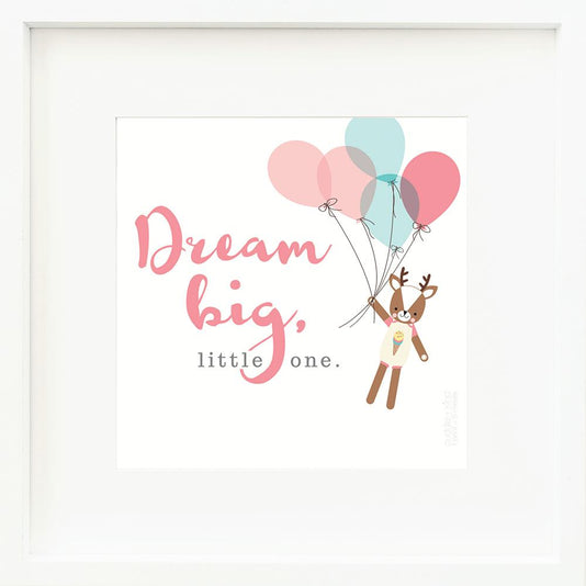 An inspirational print with a graphic of Willow the deer on a white background holding onto a bundle of pink and blue balloons, with the words “Dream big, little one” in pink and gray.