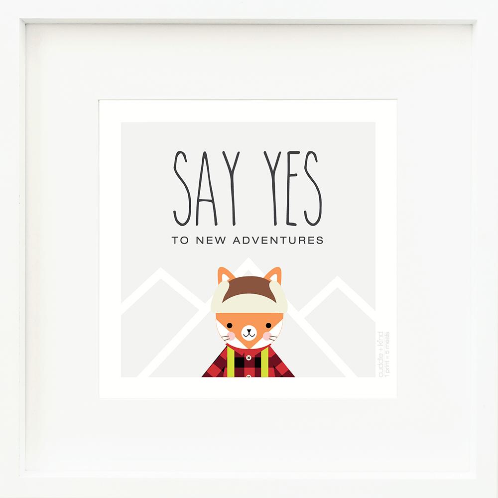 An inspirational print with a graphic of Wyatt the fox on a gray background with mountain peaks outlined in white and the words “Say yes to new adventures” in black.