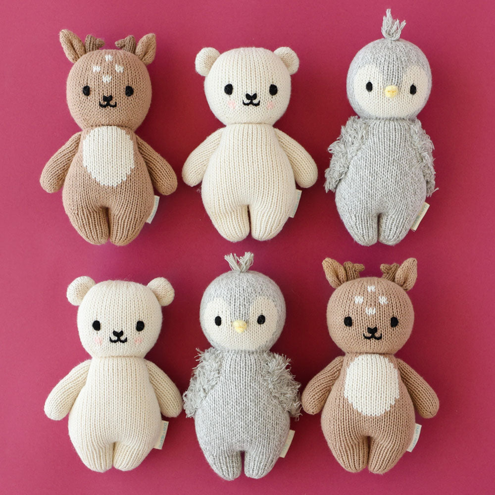 Six baby animal stuffed dolls lying in two rows of three.